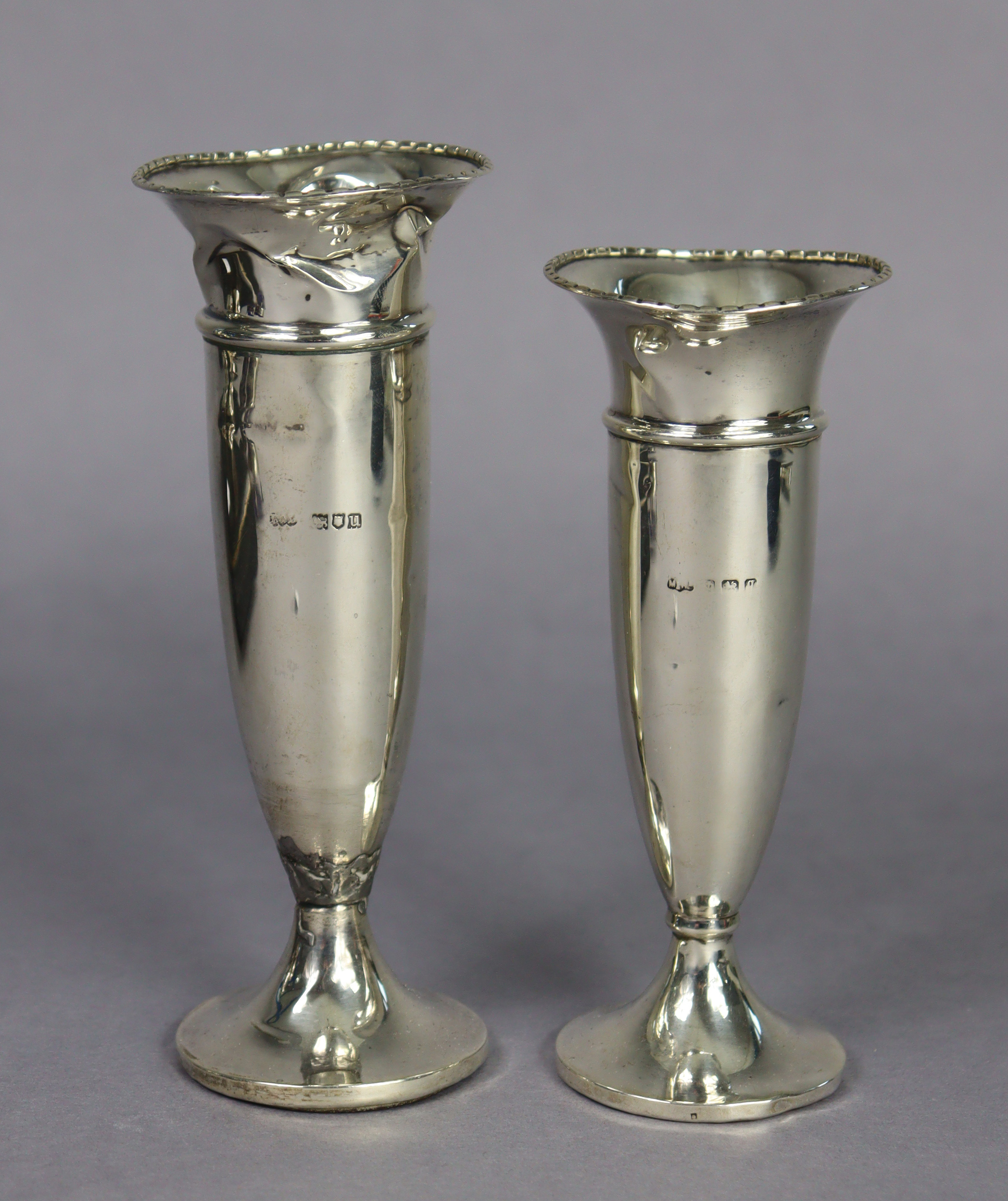 A George V silver trumpet-shaped spill vase of tapering form with loaded round pedestal foot,