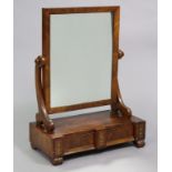 An early 19th century mahogany swing dressing mirror inset plain rectangular plate on scroll