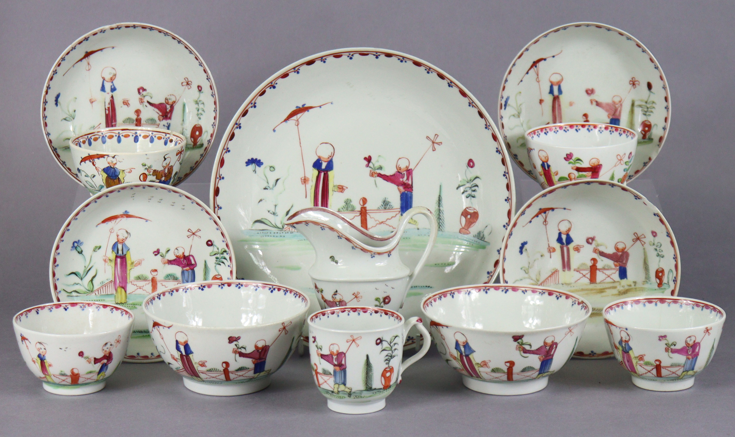 An 18th century Newhall porcelain part tea service, decorated in coloured enamels with chinoiserie