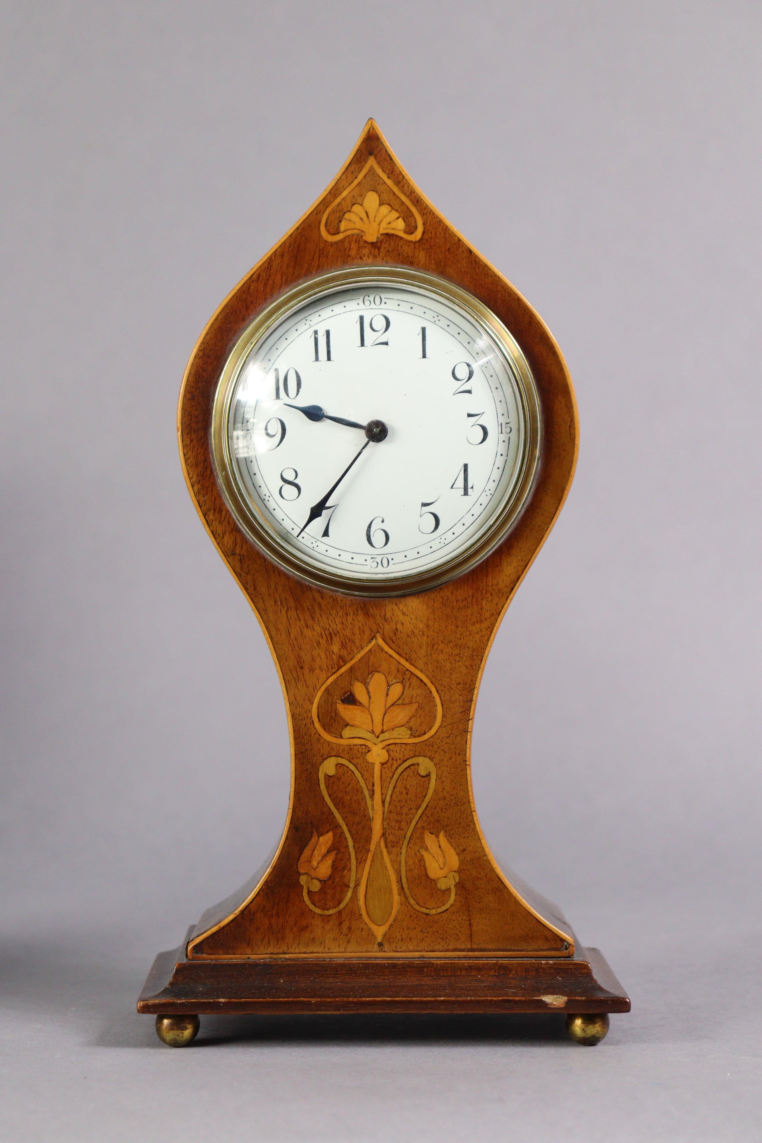 An Edwardian inlaid mahogany mantel timepiece in art-nouveau-style balloon-shaped case, the 3¼”