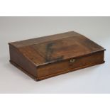 An 18th century oak clerk’s table-top desk with sloping hinged lid enclosing a drawer & pigeon