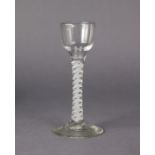 An 18th century drinking glass, on white spiral twist stem with central gauze, & on circular