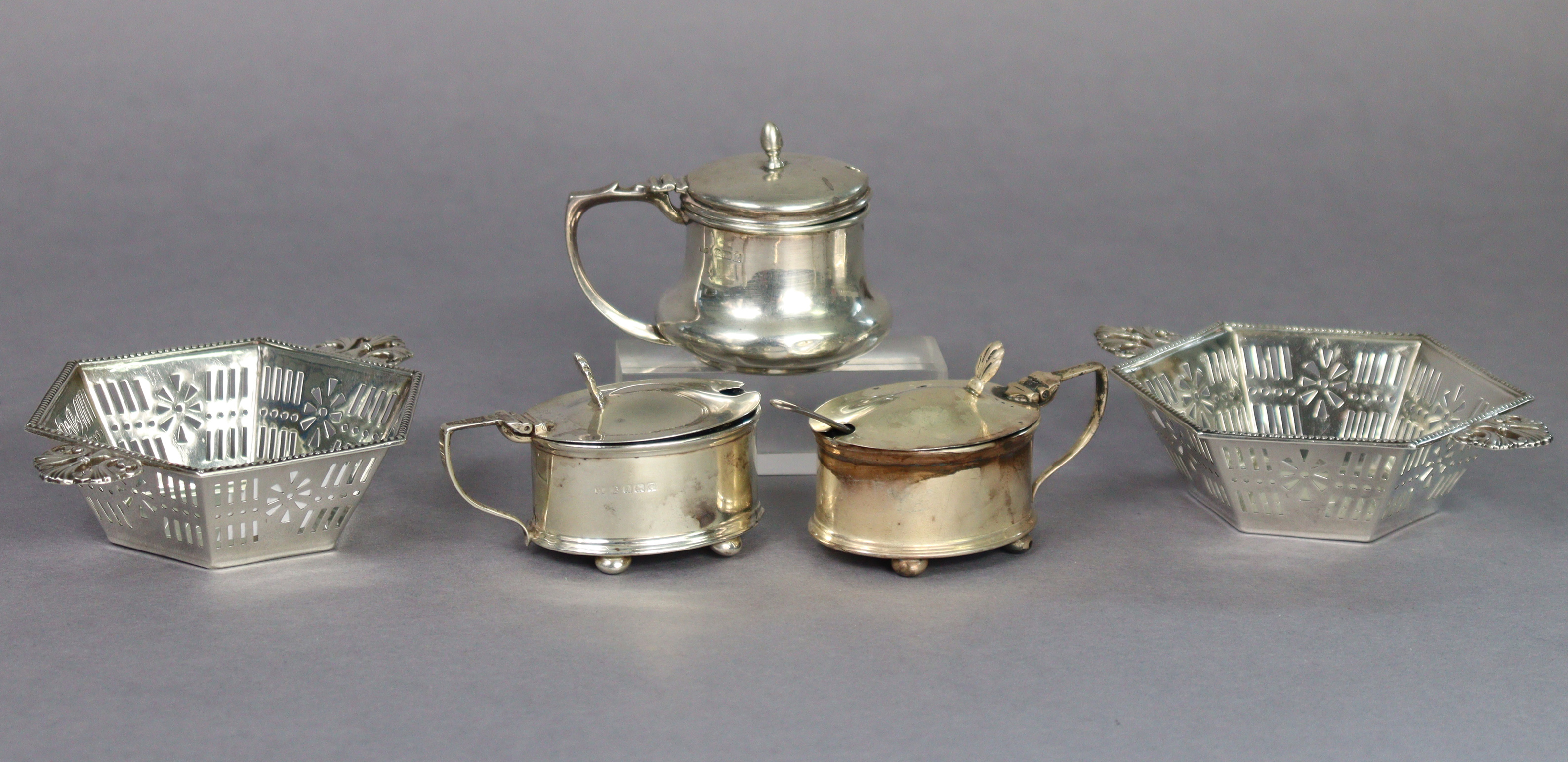 A pair of George V silver hexagonal sweetmeat dishes with pierced tapered sides & flat foliate