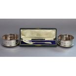 A pair of Elizabeth II silver wine coasters with plain straight sides & turned wood bases, 3¾”
