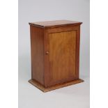 A Victorian small cabinet of rectangular form, fitted four sliding shelves enclosed by a fielded