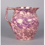 An early 19th century pink lustre pottery jug with splash decoration, 6” high x 6½” wide.