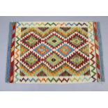 A Chobi kilim rug of ivory ground, the repeating geometric deign within narrow borders, 32” wide x