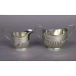 A George V silver oval semi-fluted two-handled sugar bowl & matching milk jug; Birmingham 1911, by