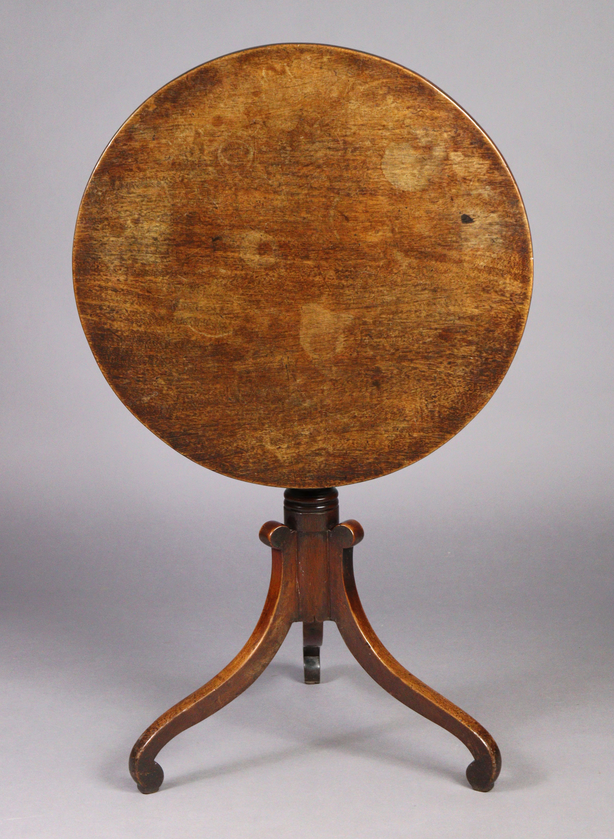 A George IV mahogany tripod table with circular tilt-top on a vase-turned centre column with three