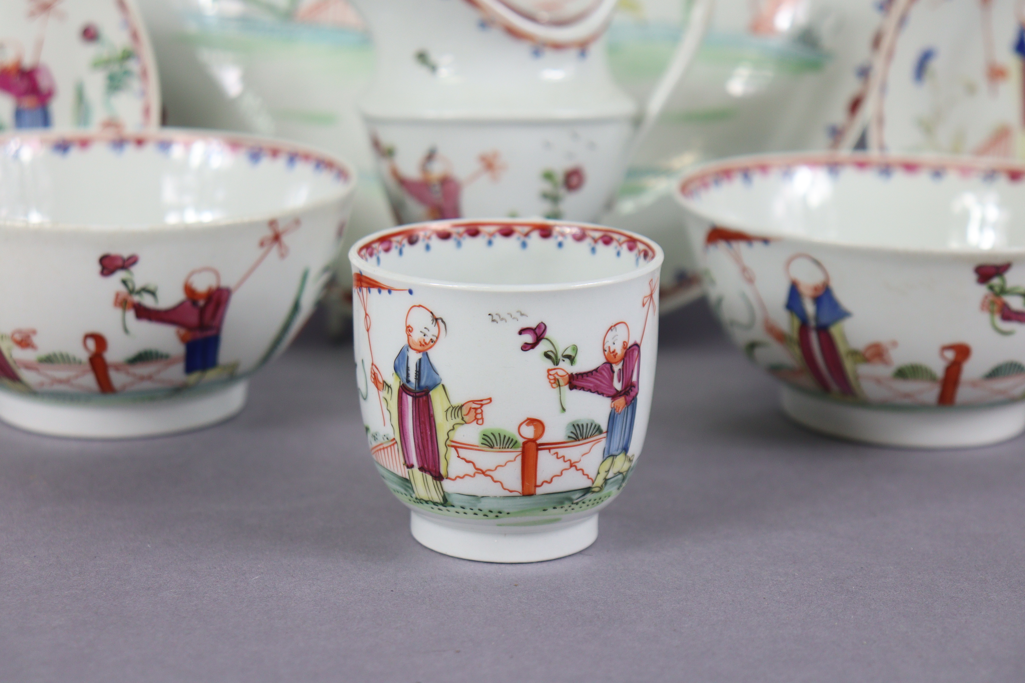 An 18th century Newhall porcelain part tea service, decorated in coloured enamels with chinoiserie - Image 2 of 17