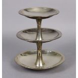 An Elizabeth II cake stand of three circular graduated dished tiers, each on a waisted central