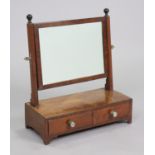 A Georgian mahogany swing dressing mirror with reeded supports, fitted two short drawers to the