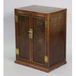 A Chinese elm cupboard with burr panels to the top, sides & pair of fielded panel doors enclosing