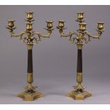 A pair of decorative black & gilt metal three branch candelabra in the neoclassical style, 21”