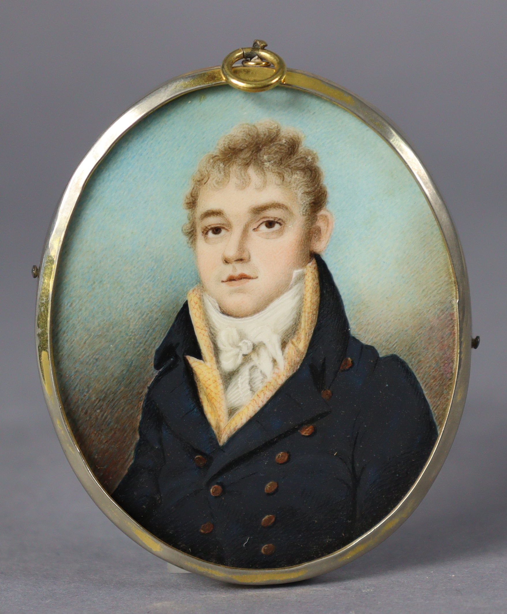 An early 19th century portrait miniature of a gentleman, wearing navy jacket with white cravat,