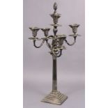 A silver-plated four-branch candelabra, the scrolling arms intertwined around a central sconce, on