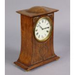 An early 20th century arts & crafts style mantel timepiece in brass-inlaid oak case with domed