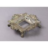 A Victorian silver square inkstand with pierced scroll sides & cast floral rim, on four cast lion-