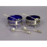 A pair of George III silver oval salt cellars with gadrooned rims, pierced straight sides, blue
