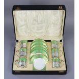 An Aynsley porcelain coffee service with green & gilt borders, the cans with pierced silver holders,