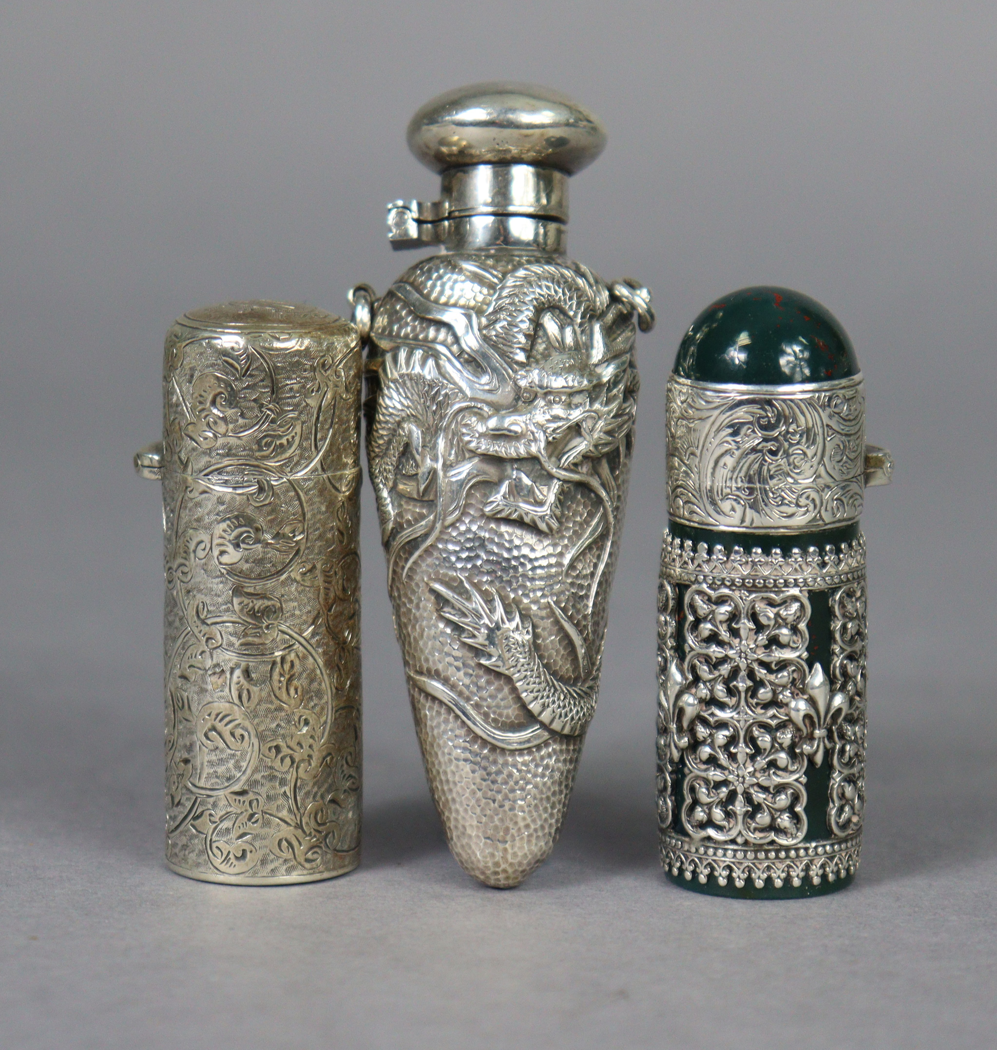 A late 19th century bloodstone cylindrical scent bottle encased in medieval style un-marked white