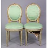 A pair of 19th century French painted salon chairs, each with rounded padded oval backs & seats,