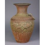 A large terracotta urn in the classical style with moulded decoration & floral rim, lacking one