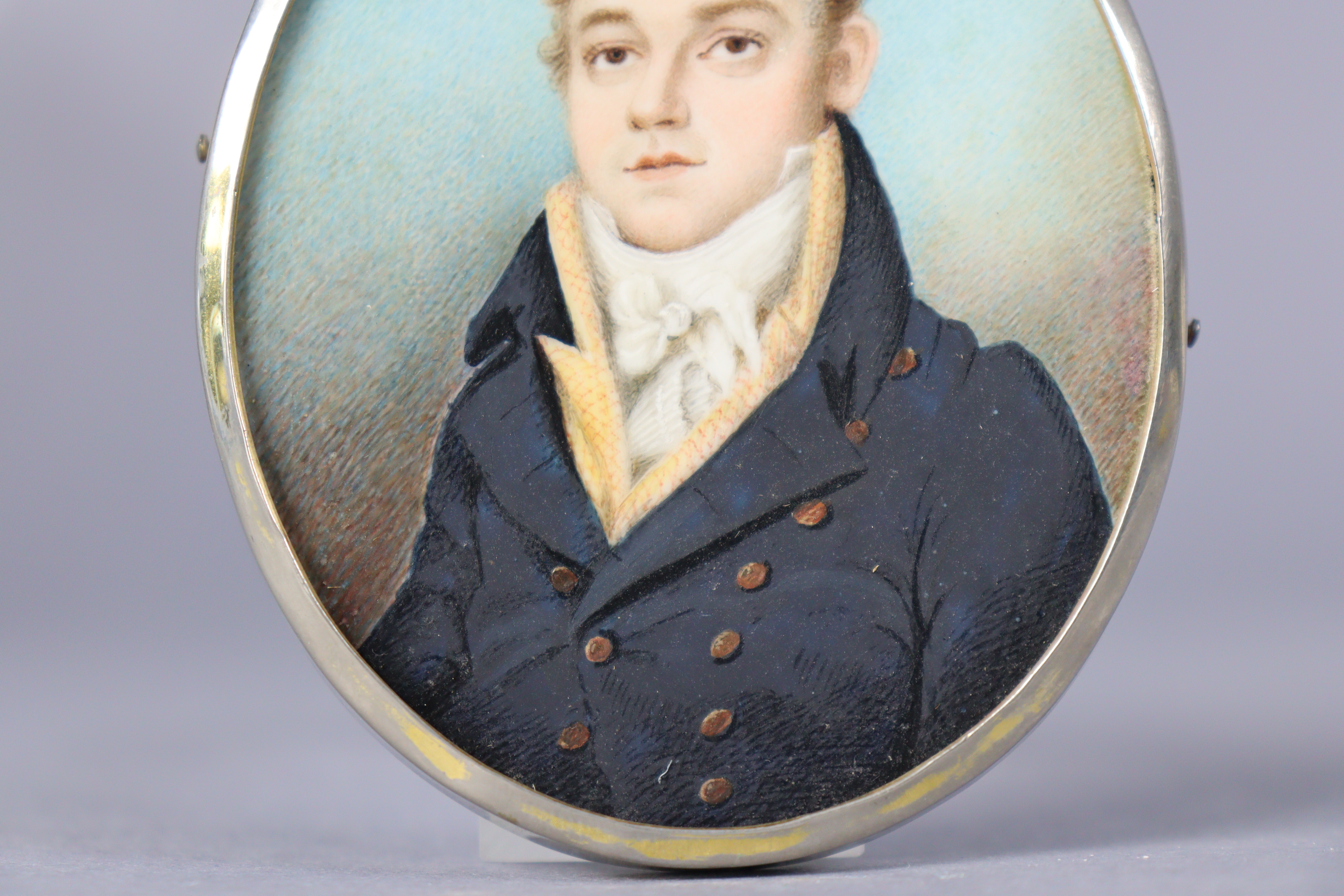 An early 19th century portrait miniature of a gentleman, wearing navy jacket with white cravat, - Image 3 of 3