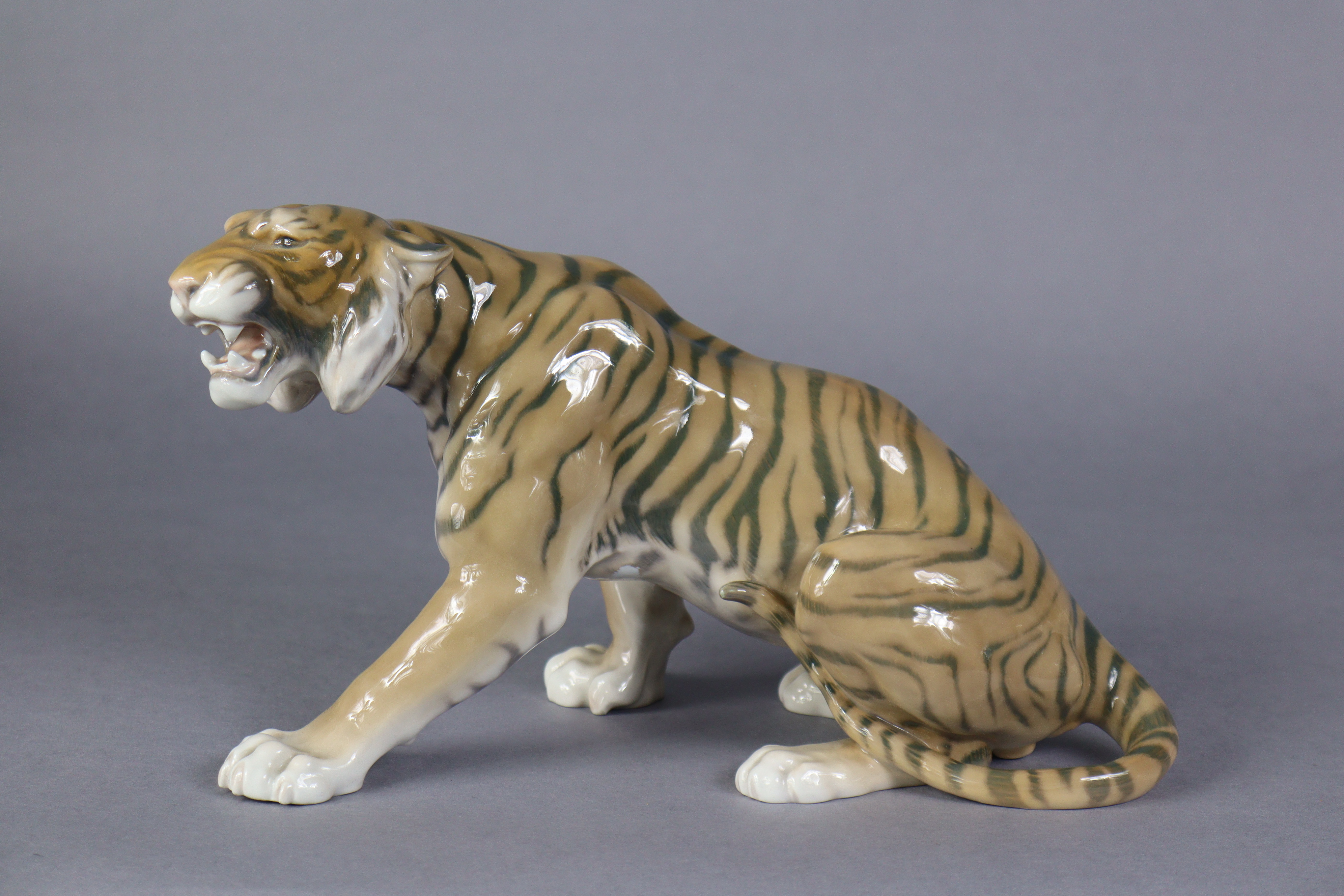 A Bing & Grondahl porcelain model of a tiger, No. 1712 by Lauritz Jensen, 11” long x 7” high. (hairl