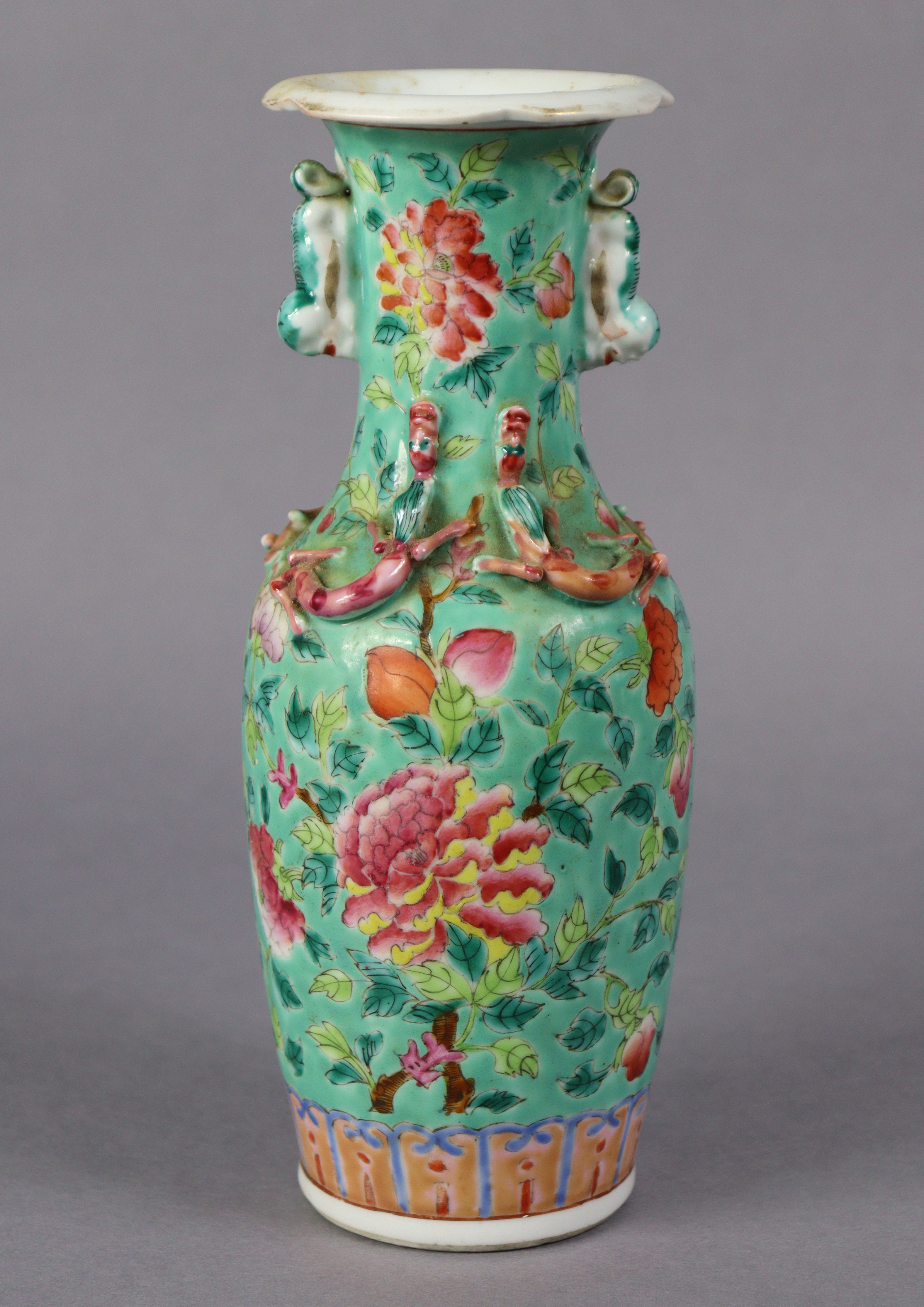 A late 19th century Cantonese porcelain small baluster vase with famille rose floral decoration on a