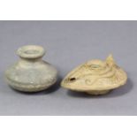 A Roman clay oil lamp with carved decoration, 3½” long, & a similar squat globular vessel with