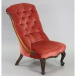 A Victorian mahogany nursing chair with buttoned back & padded seat, upholstered rose pink velour,