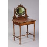 A 19th century French walnut dressing table, the oval bevelled mirror in foliate-carved frame, inset