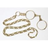 A 9ct gold lorgnette guard, 31½” long (25.4g), with pair of pendant engraved yellow metal lorgnettes