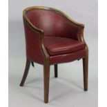 An Edwardian beech-frame tub-shaped armchair upholstered close-nailed leatherette, on square tapered