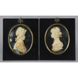 A pair of wax relief portraits of Lord Nelson & Lady Hamilton, mounted in ebonised