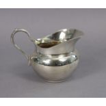 An early 20th century Christofle silver-plated cream jug of ovoid form, with scroll handle & wide