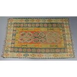 A Kilim rug of ochre ground, with repeating geometric designs in blue & camel borders; 8’ long x 58”