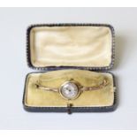 A 15ct gold ladies’ wristwatch with small engine-turned circular silvered dial, Swiss movement by