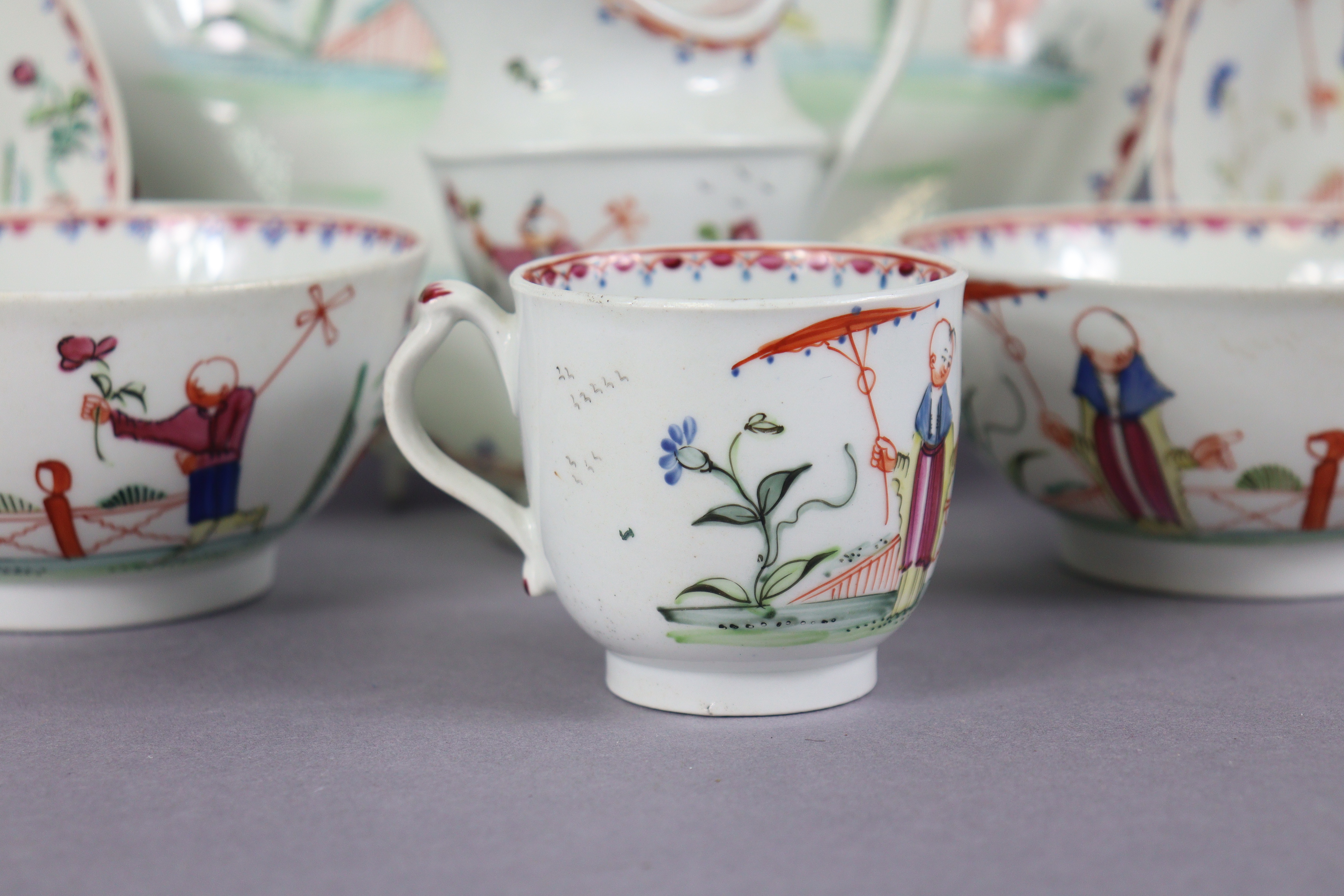 An 18th century Newhall porcelain part tea service, decorated in coloured enamels with chinoiserie - Image 3 of 17