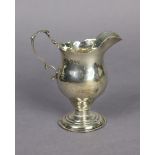 A Victorian silver cream jug in the mid-Georgian style, of ovoid shape with card-cut rim & shaped s