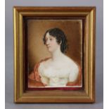 An early-mid 19th century portrait miniature of a lady, with shoulder-length curled brown hair,