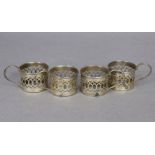 Four George V silver coffee can holders with straight pierced sides; Birmingham 1926, by Deakin &