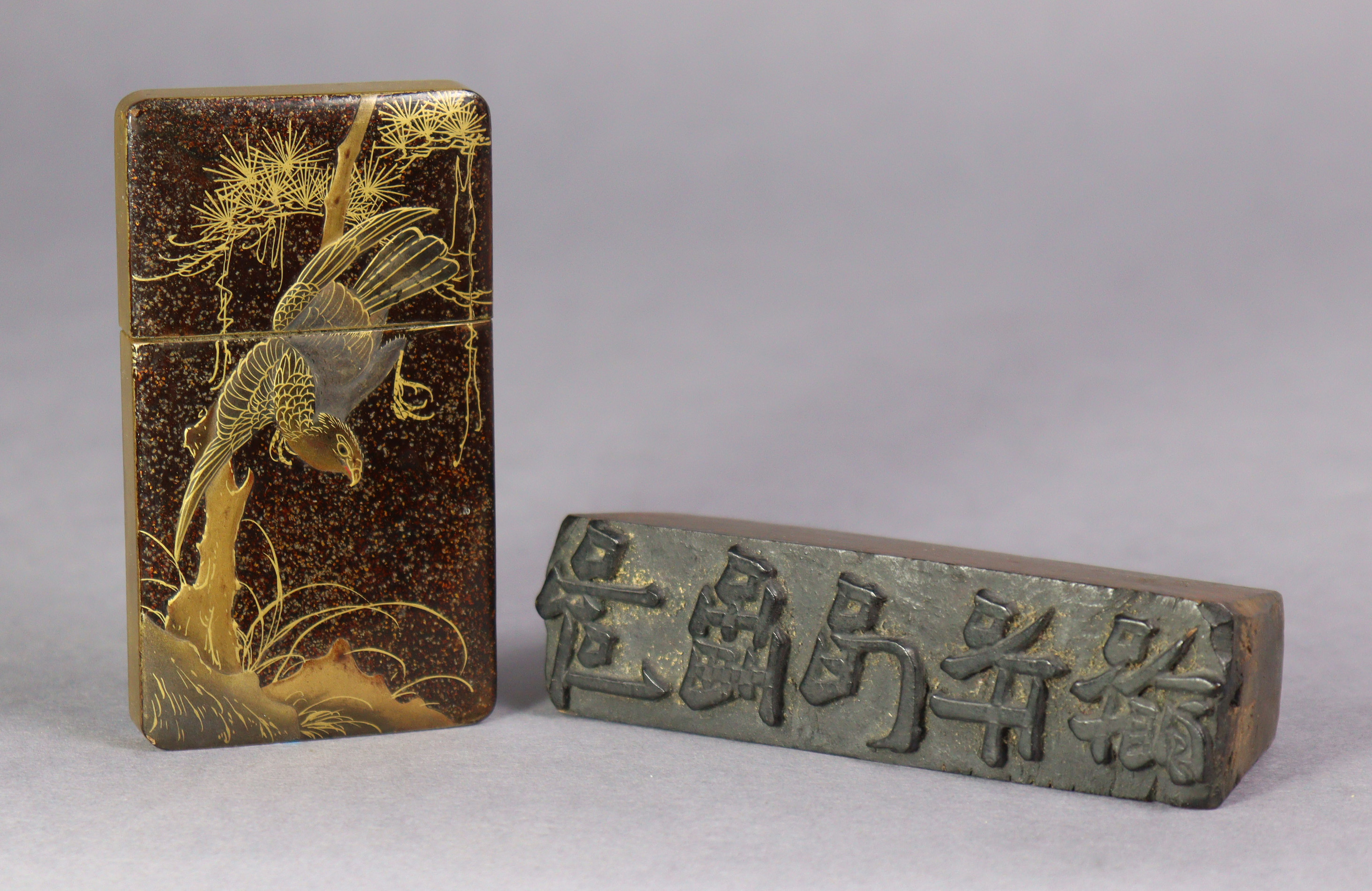 A late 19th century Japanese lacquer card case decorated with a hawk on a gilt-speckled ground,