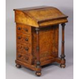 A Victorian burr walnut davenport with shaped sloping hinged cover enclosing felt writing