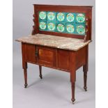 An Edwardian walnut marble-top washstand inset tiles to the stage-back, with cupboard enclosed by