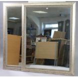 A large pair of rectangular wall mirrors each in a silvered-finish frame & with a rope-twist border,