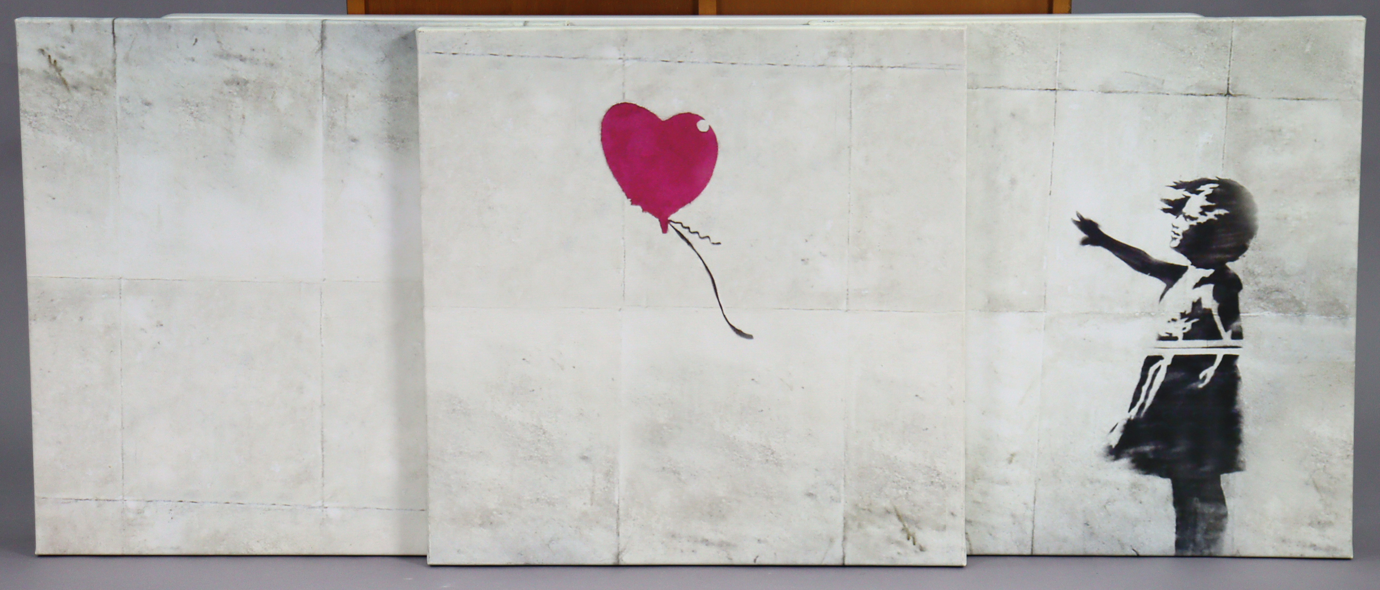 A Banksy Triptych print on canvas – Balloon Girl, each canvas, 30” x 30”; & eleven “cargo” white