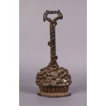 A Victorian cast iron door stop in the form of a basket of fruit, 14” high x 5½” wide.