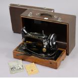 A Singer electric-operated sewing machine, with case.